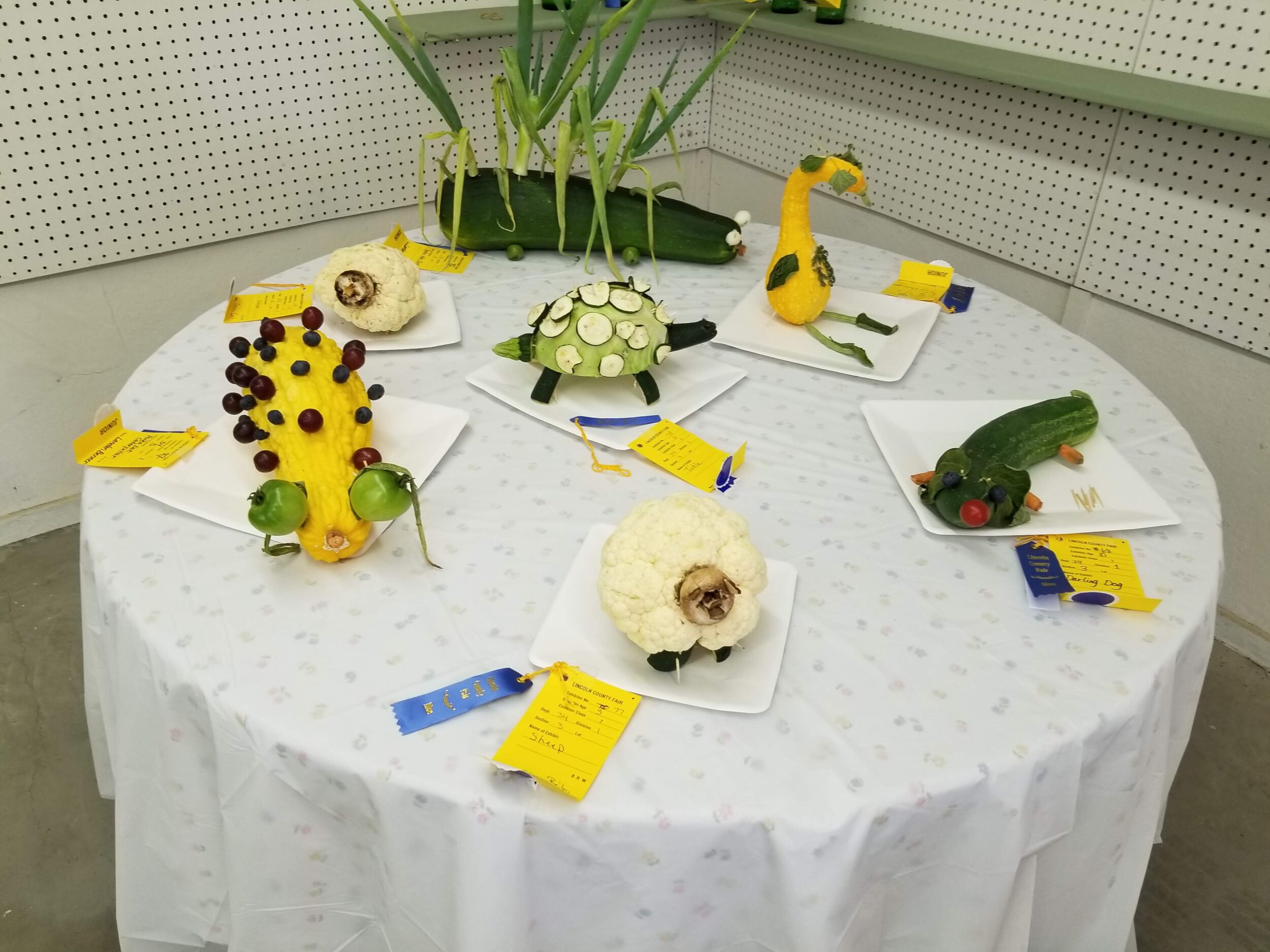 Table with vegetables decorated as animal or creepy critters, Foral Department.